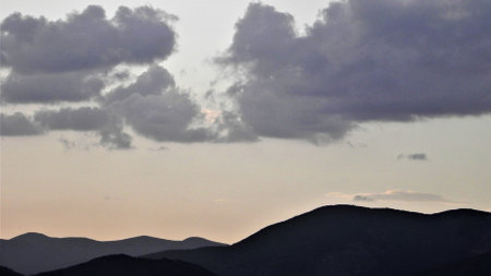 A processed square version of a photograph that displays clouds above a South American mountain range.の写真素材