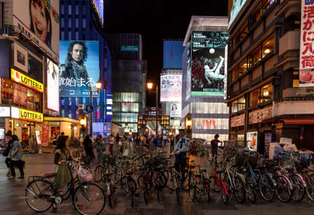 Osaka Japan - June 20, 2010  Bicycle parked in Dotombori district in the background of neon lights on June 20, 2010 in Osaka, Japan  Dotombori is the main entertainment district in Osaka のeditorial素材