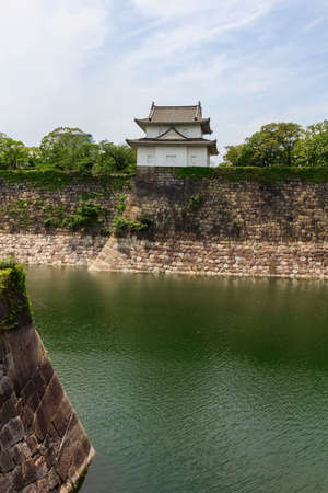Osaka Japan - June 17, 2010  Fragments of Osaka Castle with big moat in the foreground on June 17, 2010 in Osaka, Japan のeditorial素材