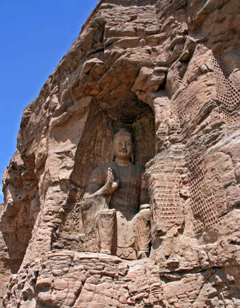 Datong, China - July 21, 2009  One of the numerous Buddha reliefs of the Yungang Grottoes on July 21, 2009  Yungang Grottoes are one of the most spectacular highlights of buddhist art in China のeditorial素材