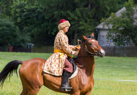 Oblegorek, Poland - July 15, 2012   History fan dressed as 17th century Polish cavalryman with a sabre in his hand at a free public reenactment show in Oblegorek on July 15, 2012  のeditorial素材