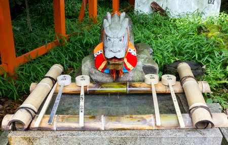 Purification ladles and a dragon statue in a shinto shrine in Japanの写真素材