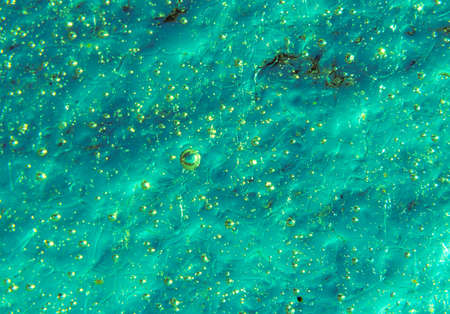 green texture background, macro photo of irregular pattern of ice structure with bubbles and cracksの写真素材