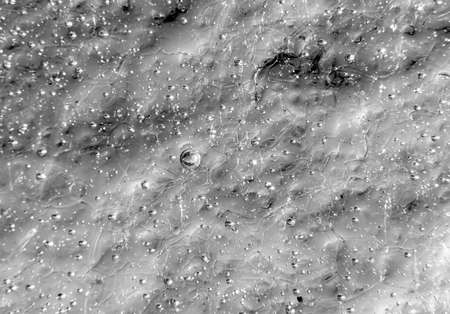 silver texture background, macro photo of irregular pattern of ice structure with bubbles and cracksの写真素材