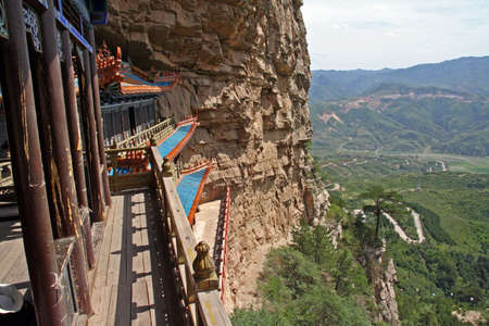 A Taoist temple carved in rock with large vistas of space below in North China, near Datong, Shanxi Provinceの写真素材