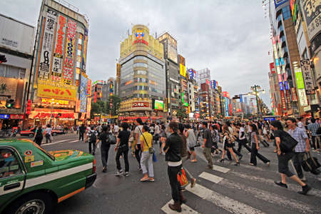 Tokyo, Japan - June 26, 2010  Busy streets in Shinjuku district, with crowds of people, green Tokyo taxi and neons in background on 26 June 2010 のeditorial素材
