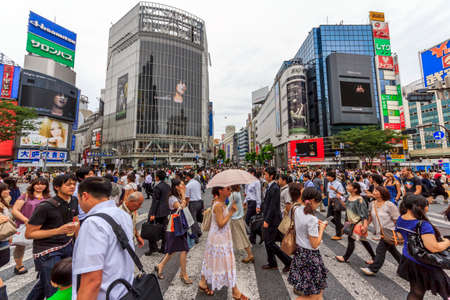 Tokyo, Japan - June 26, 2010  Wideangle photo of the crowds of people at Shibuya Crossing on a cloudy day on 26 June 2010  Shibuya is probably the best known meeting place in Tokyo のeditorial素材