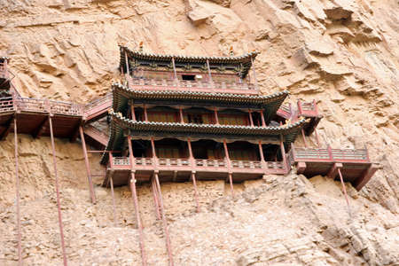 Heng Shan, China - July 21, 2009  Famous hanging monastery in Shanxi Province near Datong, China, viewed from distanceon July 21, 2009  Hanging monastery is one of the greatest architectural marvels in China のeditorial素材