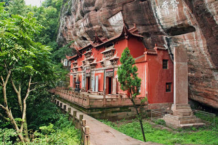 Temple building leaning against a vertical rock in Qiyun Taoist complex, china, stylized and filtered to resemble an oil painting のeditorial素材