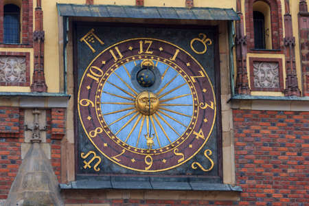 old beautiful clock on thedecorated facade of the city hall, Wroclaw, Poland