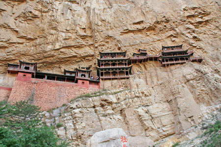 Famous hanging monastery in Shanxi Province near Datong, China, viewed from below, stylized and filtered to resemble an oil painting.の写真素材
