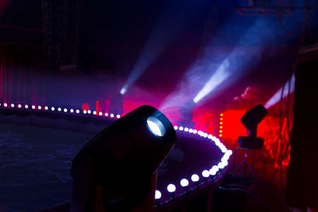 patches of light coming from the dark silhouettes of stage lights directed at audienceの写真素材