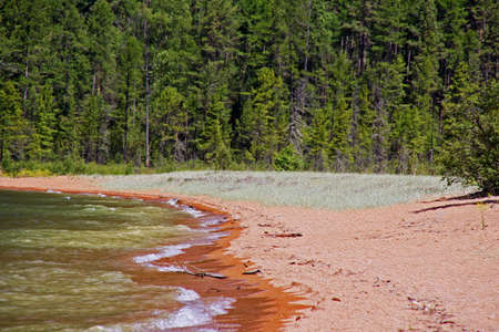 wild shores of Lake Baikal in Russian Siberia - sandy beach and forest in background,  stylized and filtered to resemble an oil paintingの写真素材