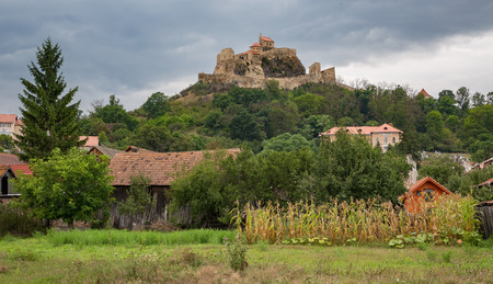 Rupea Castle near Brasov, medieval fortress in Romania with gray cloudsのeditorial素材