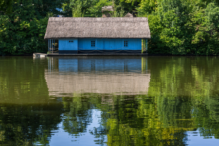 Blue house has a reflection on a river with quiet waterの写真素材