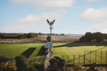 Aerial view of an empty stadium in daylight. Located in the countryside.