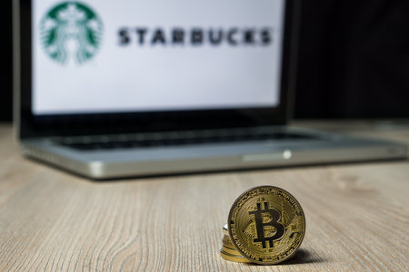 Bitcoin coin with the Starbucks logo on a laptop screen, Slovenia - December 23th, 2018のeditorial素材