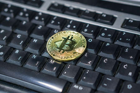 Background with bitcoin on the computer keyboardの写真素材
