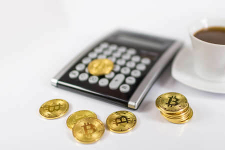 Bitcoin coin with calculator as a tax payment conceptの写真素材