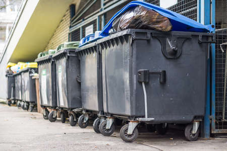 Overflowing garbage bins with household waste in the cityの写真素材