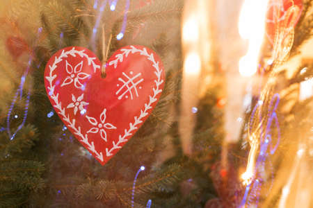 Red heart on spruce and pine background. Valentines Day. Symbol of love. Copy space.の写真素材