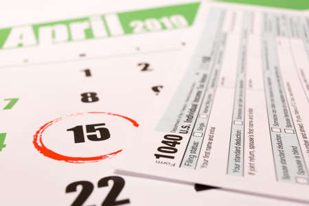2019 calendar with 1040 income tax form for 2018 showing tax day for filing on April 15の写真素材