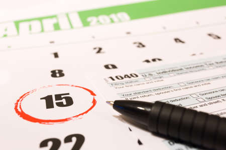2019 calendar with 1040 income tax form for 2018 showing tax day for filing on April 15の写真素材