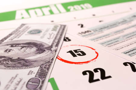 2019 calendar with 1040 income tax form for 2018 showing tax day for filing on April 15の写真素材