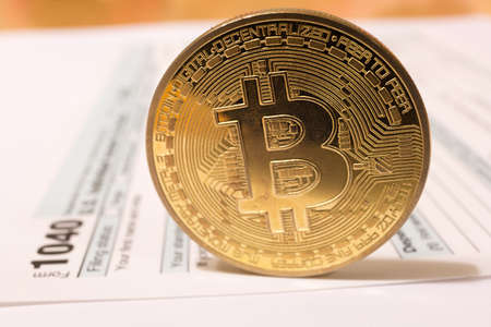 Bitcoin coin with 1040 income tax form for 2018 for filing on April 15の写真素材