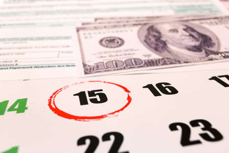 2019 calendar with 1040 income tax form for 2018 showing tax day for filing on April 15の写真素材