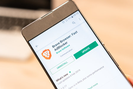 Brave Browser app on Google Play Store website displayed on smartphone and computer laptop in background. Slovenia 13.02.2019のeditorial素材
