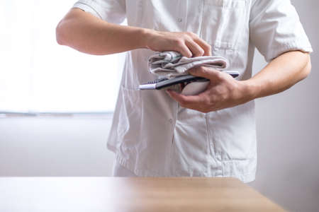Doctor in the uniform cleaning his equipmentの写真素材