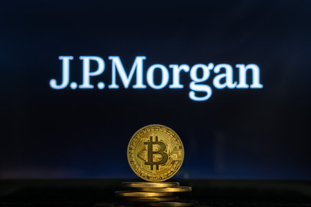 Bitcoin on a stack of coins with JP Morgan logo on a laptop screen. Cryptocurrency and blockchain adoption getting mainstream. Slovenia - 02 24 2019