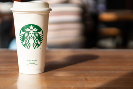 Slovenia 27.2.2019 - Starbucks take away, hot beverage coffee cup with logo, on the table in store.のeditorial素材