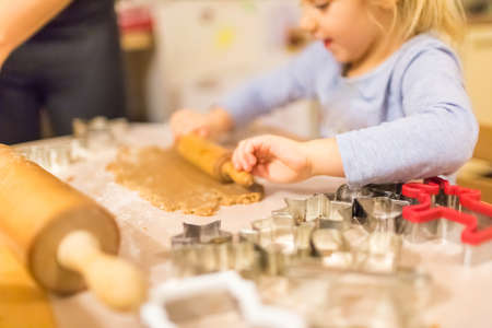 Baking with the family - Mother and daughter making self made cookies in a home kitchen