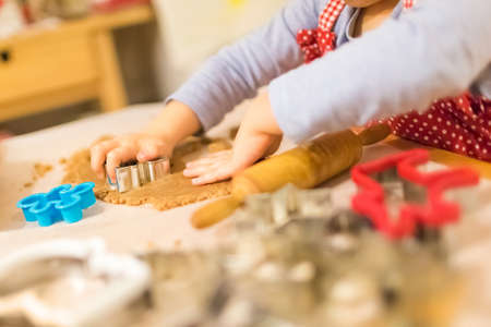 Baking with the family - Mother and daughter making self made cookies in a home kitchen