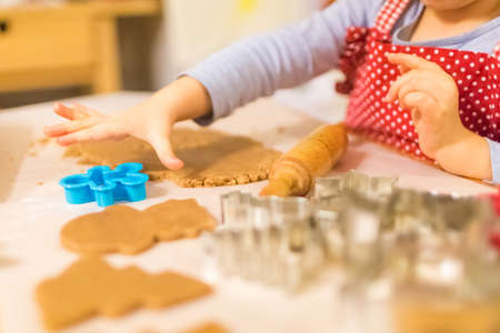 Baking with the family - Mother and daughter making self made cookies in a home kitchenの写真素材