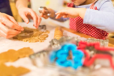 Baking with the family - Mother and daughter making self made cookies in a home kitchenの写真素材