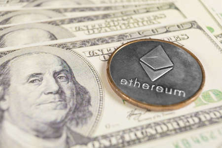 Ethereum crypto coin on dollar notes backgroundの写真素材
