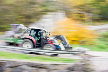 Tractor in full speed motion passing byの写真素材