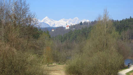 View on a path of the alps with the church and the forestの写真素材