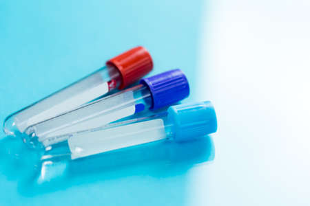 Bottles for samples used in hospitals or medicine for blood samples in a laboratory on a blue backgroundの写真素材