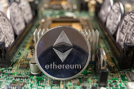 Ethereum coin close-up on a computer circuit motherboard as a blockchain technology payment network....