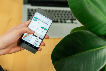 Ljubljana, Slovenia 29.4.2019: Businessman holding smartphone and trying to download n26 banks appのeditorial素材