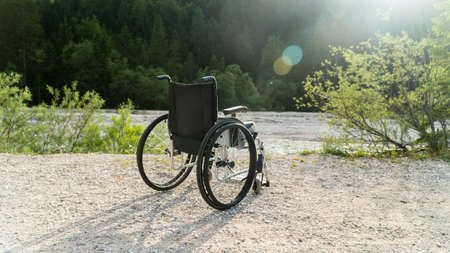 Empty wheelchair parked in park, health care concept