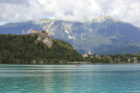Lake Bled Slovenia. Beautiful mountain lake in summer with small Church on an island with castle on cliff and european alps in the background.の写真素材