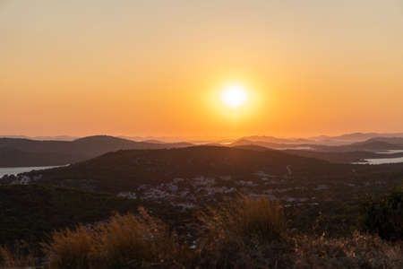 Beautiful sunset landscape above the sea and cityの写真素材