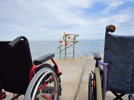 Wheelchairs on an accessible beach for transportation of people with disabilities in the water.の写真素材
