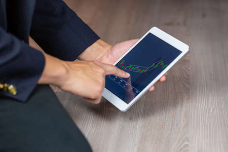 Stock Trader Looking At Stock Chart on Screen