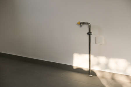 Natural Gas pipes on white wall in house kitchen